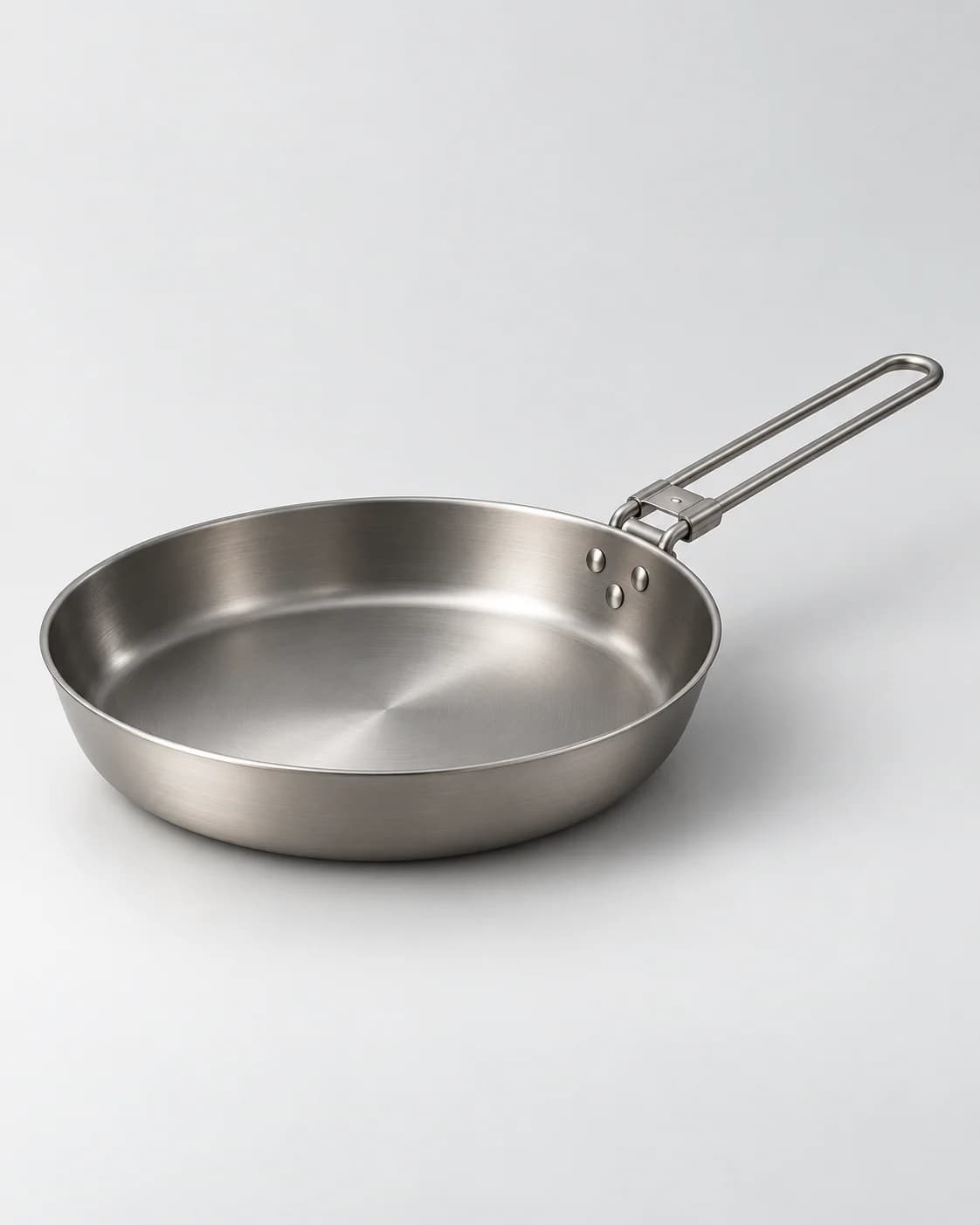 AI-generated illustrative visual of a metal frying pan on a light neutral background